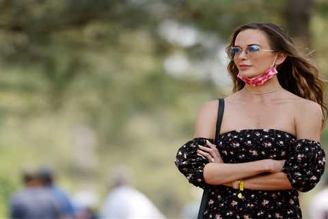 Jena Sims shows off huge diamond engagement ring as she cheers on Brooks Koepka during practice..