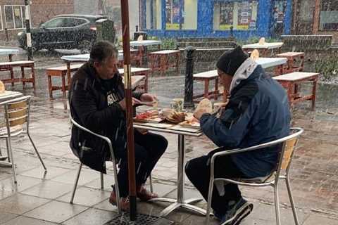 Thirsty Brits brave SNOW &amp; queue from midnight in -3C temperatures as pub beer gardens reopen..