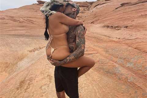 Kourtney Kardashian bares all in thong bikini as she wraps her legs around boyfriend Travis Barker..