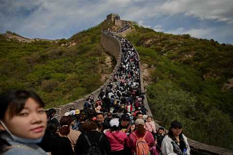 Tourists pack together on Great Wall of China with no face masks or social distancing as Beijing..