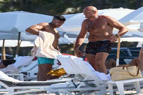 Tyson Fury does his best to avoid female attention on the beach with brother Tommy after being..