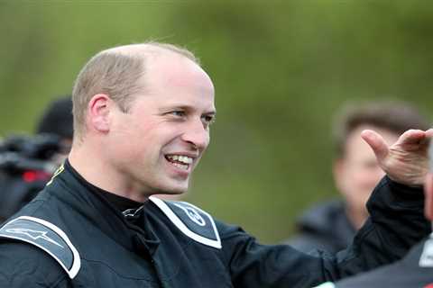 Grinning Prince William shrugs off Royal drama as he hops into racing car and takes it for a spin..