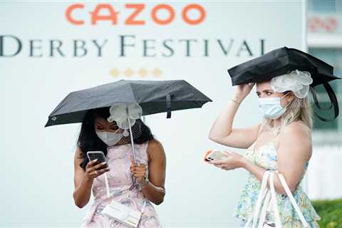 Rain fails to dampen Derby spirits as 4,000 punters make way to Epsom for racing in pouring rain