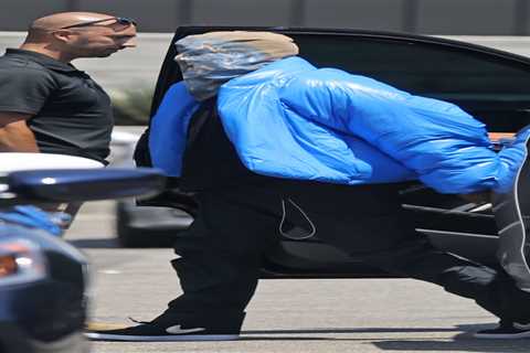 Kanye West seen without wedding ring and hides entire face under bizarre mask after Kim Kardashian..