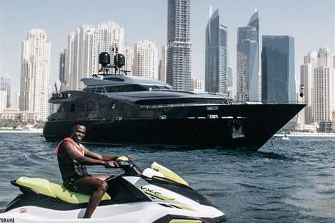 Chelsea star Edouard Mendy rides jet ski in front of yacht in Dubai as he relaxes during summer..