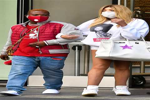 Wendy Williams holds Ray J’s arm as they leave her home the morning after she boasted about their..