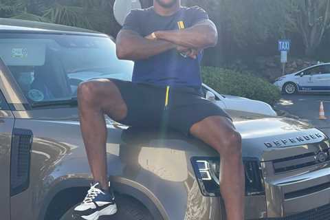 Anthony Joshua poses on Range Rover after driving to watch pub for England’s Euro 2020 showdown..