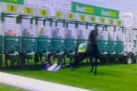 Jockey Saffie Osborne receiving medical treatment after being dragged under stalls by horse at..