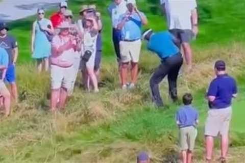 Hilarious moment Vijay Singh shanks ball and hits fan who falls off chair spilling beer on himself..