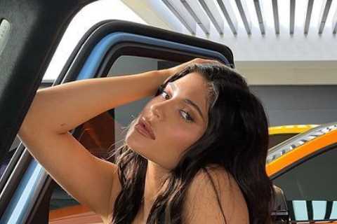 Kylie Jenner shows off her tiny figure in strapless top as fans continue to speculate star is..