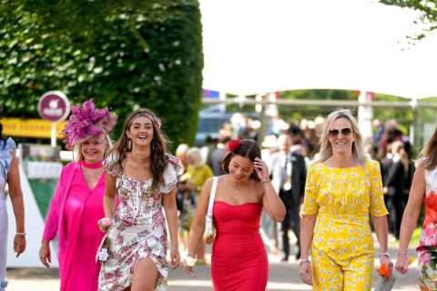 Glam racegoers step out in colourful dresses and towering hats for Goodwood ladies’ day