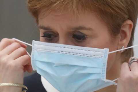 Scots will have to carry on wearing face masks for ‘some time’ in pubs and schools, says Sturgeon,..