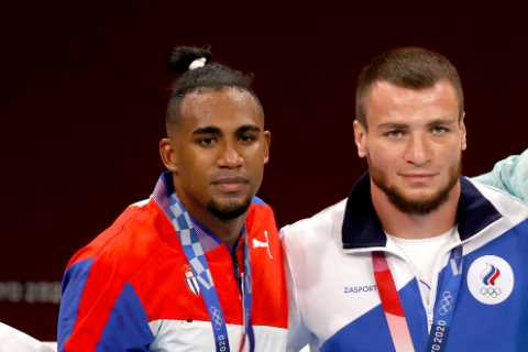Team GB boxer Ben Whittaker REFUSES to wear silver medal on podium after losing Olympic final..