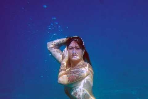 American Pickers star Danielle Colby goes completely nude in underwater photoshoot after flashing..