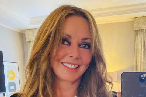 Carol Vorderman, 60, shows off her curves in a slinky black dress