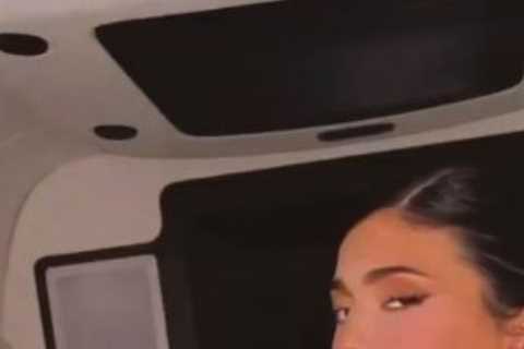 Pregnant Kylie Jenner shows off her bare baby bump and chows down on cake during NYFW event