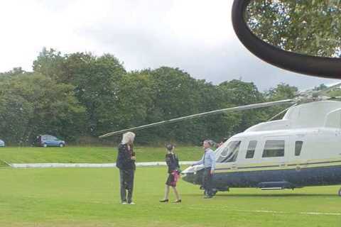 Queen star Brian May stopped play by landing his helicopter in the middle of a cricket pitch