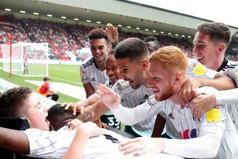 Fulham celebrate goal with Rhys Porter, 13, a fan with cerebral palsy, and make him squad member..