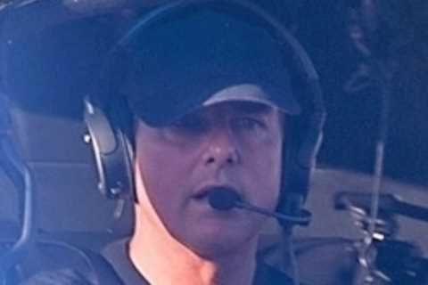 Tom Cruise looks tense as he lands his helicopter in London after wrapping up Mission Impossible 7..