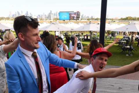 Melbourne Cup punters soak up the sunshine and booze as nine arrested after storming gates at ‘race ..