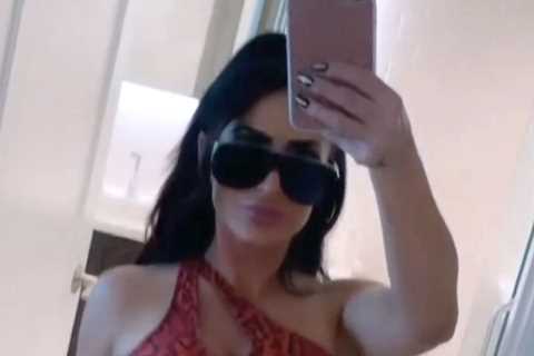 Jersey Shore’s Angelina Pivarnick poses in snakeskin sports bra &amp; pants after posing with..