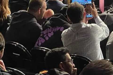 Dana White pictured watching Canelo Alvarez’s fight with Caleb Plant on TV while sitting in front..