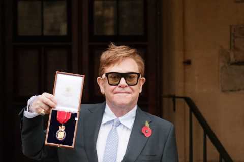 Sir Elton John receives gong from Prince Charles after hip surgery