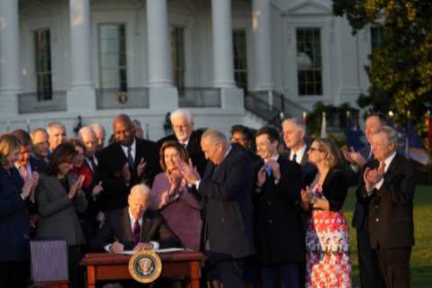 Biden hailed bipartisanship as he signed an infrastructure bill he said would make life ‘better’..