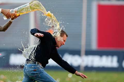 Watch Man Utd manager Ralf Rangnick pull hamstring as RB Leipzig stars pour beer over his head to..