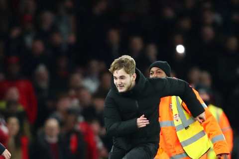 Watch as Arsenal boss Arteta is forced to jump out of pitch invader’s path as fan storms pitch..
