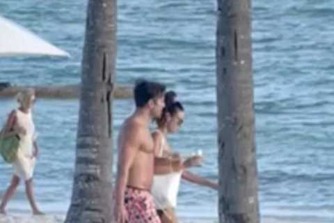 Mark Wright and Michelle Keegan look loved-up on the beach together as they soak up the sun in..