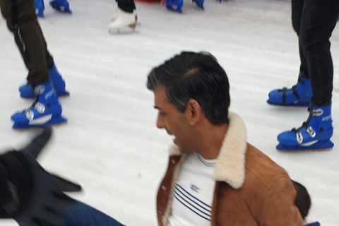 Rishi Sunak squishes daughter as he slips on ice rink during family day out