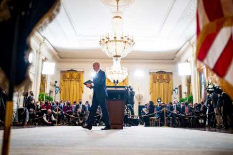 Biden says he will pursue a scaled-back agenda as he defends his first year in office.