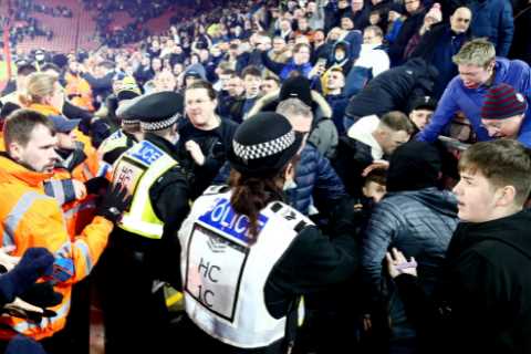 Man City face FA probe as three fans hauled off pitch and others fight with police in stands during ..