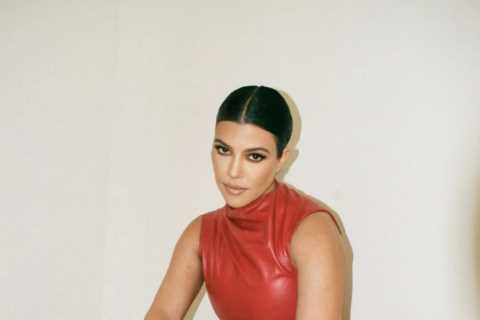 Kourtney Kardashian shows off natural short hair without extensions as she poses in red leather..
