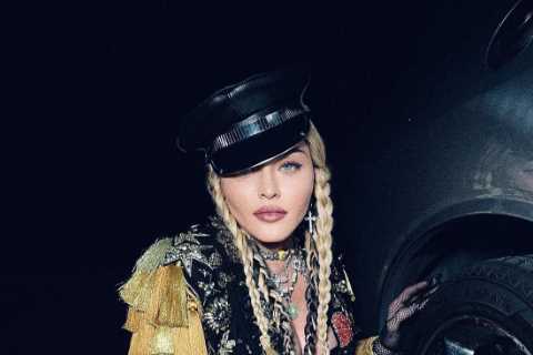 Madonna, 63, strikes a cheeky pose after running into car trouble