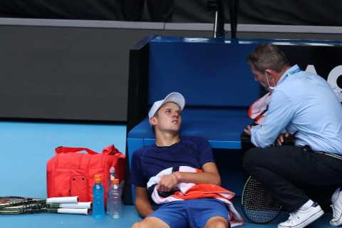 Watch worst attack of cramp ever as Mensik, 16, collapses on court and is forced off in wheelchair..
