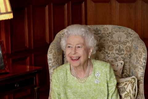 Queen beams with pride as she celebrates 70 years on the throne next to picture of her beloved..