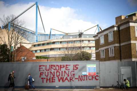 Workers paint over graffiti outside Stamford Bridge after fuming Chelsea fans deface hoardings