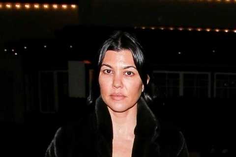 Kourtney Kardashian goes make-up free on family outing with Travis Barker as fiancé holds her..