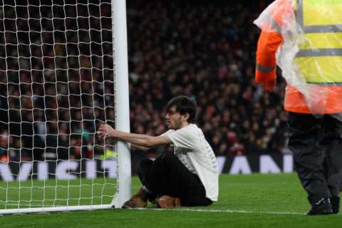 Arsenal’s clash against Liverpool stopped after pitch invader HANDCUFFS himself to goal post