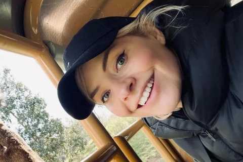 Holly Willoughby looks fresh-faced as she feeds a giraffe on fun family day out