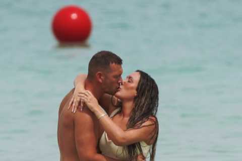 Pregnant Charlotte Crosby kisses boyfriend Jake as he touches her baby bump on holiday in Dubai