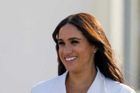 Meghan pulls out all the stops in a crisp £6,210 power suit as she joins Harry for Invictus Games..