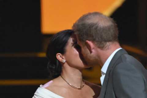 Beaming Meghan Markle kisses Prince Harry on stage at Invictus Games opening ceremony