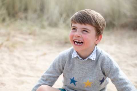 Prince Louis beams as he plays on the beach in cute photos released to mark his fourth birthday