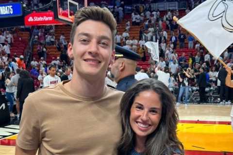 F1 star George Russell on big screen at NBA game with stunning girlfriend as Mercedes driver..