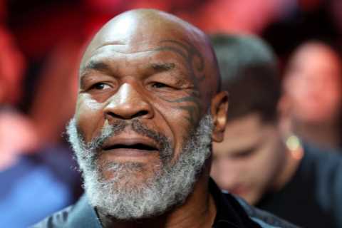Mike Tyson grins with wife Lakiha ringside as they watch shock Canelo Alvarez defeat to Bivol in..
