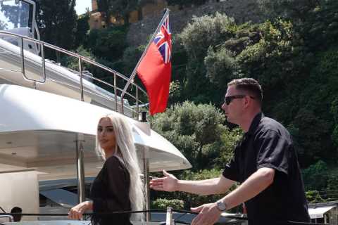 Kim Kardashian stuns in sheer black dress while Kourtney rocks gothic veil during family yacht..