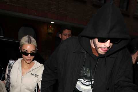 Kim Kardashian shows off VERY tiny waist in metallic white pants as she holds hands with Pete..